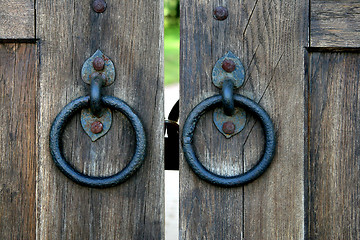 Image showing ancient wooden gate with door knocker rings