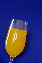 Image showing Yellow drink over blue