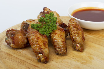 Image showing Grilled chicken wings with sauce and parsley