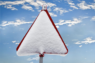 Image showing A red sign warns of snow