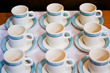 Image showing nine white porcelain tea cups and saucers and napkins