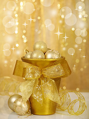 Image showing christmas baubles in gold vase