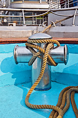 Image showing Metal bollard with rope on a ship deck