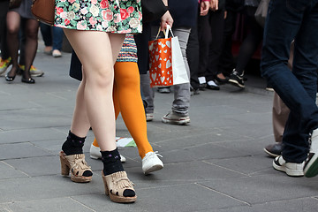 Image showing Women legs in crowd