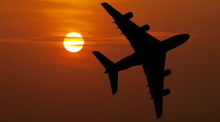 Image showing Airliner over red sunset