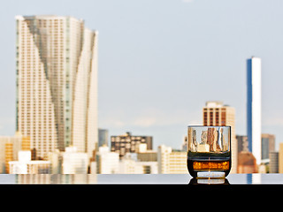 Image showing A glass of whisky with panoramic city view