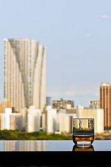 Image showing A glass of whisky with city view on background