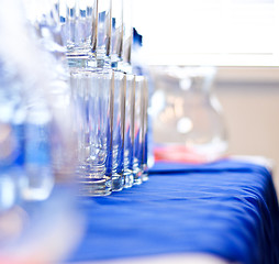 Image showing several glass glasses on a blue napkin