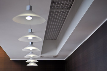 Image showing several modern chandeliers on the ceiling in the bar