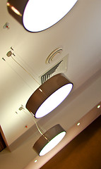Image showing several modern chandeliers on the ceiling in the bar