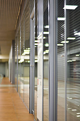 Image showing Wall with glass partitions and doors in office building