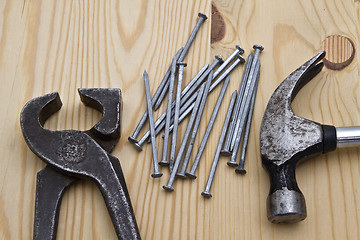 Image showing hammer ,wrench and nails on wood background 