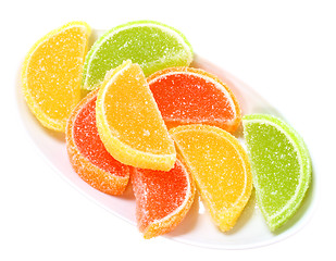 Image showing Group of sweets as citrus fruits on white plate