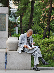 Image showing Old Korean man reading at Tapol Park, Seoul, South Korea