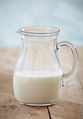 Image showing closeup of milk on old wooden table