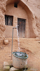 Image showing Water tap and cave dwellings