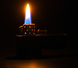 Image showing Lighting flame on dark background