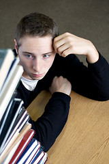 Image showing Overloaded Student Looking At Pile of Books