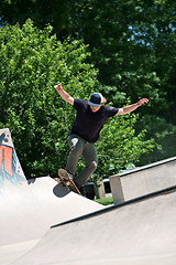 Image showing Skateboarder Riding Up a Concrete Skate Ramp