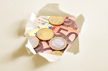 Image showing euro money behind hole in paper