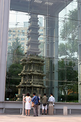 Image showing Tourists look at a Buddhist structure - travel and tourism