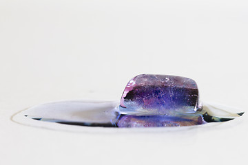 Image showing Purple ice cube melting