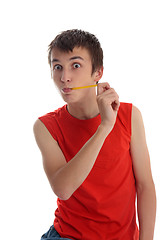 Image showing Boy stretching a jelly snake candy