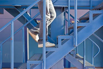 Image showing A man running up the stairs