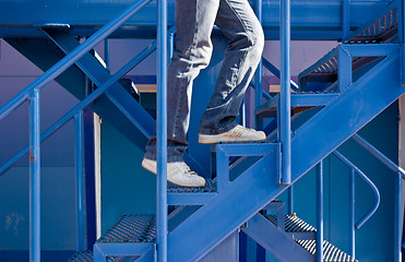 Image showing A man running up the stairs