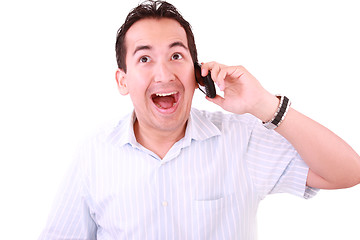 Image showing Beautiful young man laughs and talks by mobile phone. 