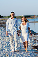 Image showing Young couple walking on beach