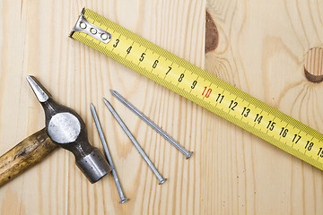 Image showing Old hammer , tape measure and nails 