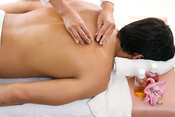 Image showing Man receiving thermal stone massage