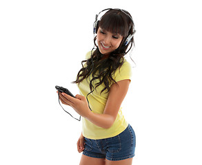 Image showing Happy girl using a music player