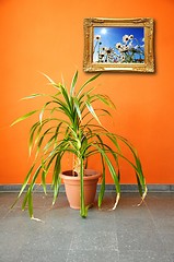 Image showing picture on a wall and plant