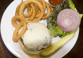 Image showing cheeseburger onion rings pickle onions lettuce