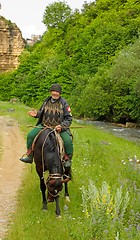 Image showing An elderly mountain dweller on horseback