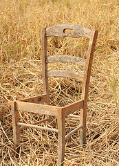 Image showing broken chair on yellow grass