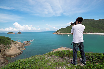 Image showing photographer takes a photo of the landscape 