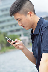 Image showing man checking his phone outdoor