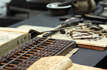 Image showing abacus and book on the table in a chinese old shop