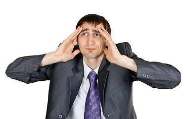 Image showing businessman in a gray suit with a headache in the studio