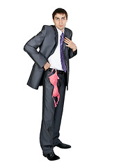 Image showing businessman in a gray suit from his pocket a pink bra hanging