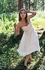 Image showing girl in a cream dress in a forest