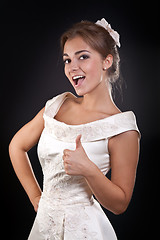 Image showing Beautiful girl in dress shows OK in the studio