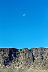 Image showing Moon on a background of blue sky and mountains