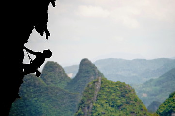 Image showing Climbing a steep rocky cliff