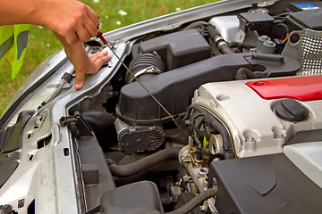 Image showing Checking engine oil