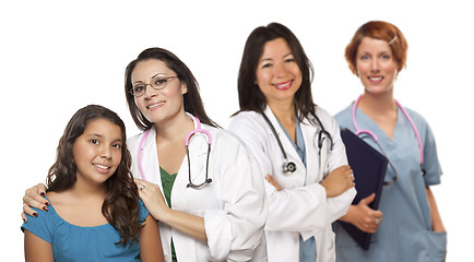 Image showing Hispanic Female Doctor with Child Patient and Colleagues Behind