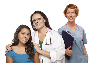 Image showing Hispanic Female Doctor with Child Patient and Colleague Behind